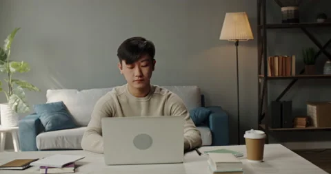Young hardworking asian manager working from home on laptop, typing on keyboard Stock Footage 130746407