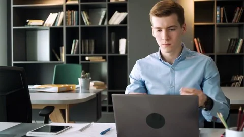 Young hardworking man take part in video conference call to report to boss using Stock Footage 79785209