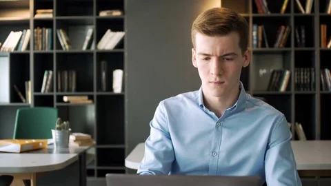 Young hardworking man take part in video conference call to report to boss using Stock Footage 79785356