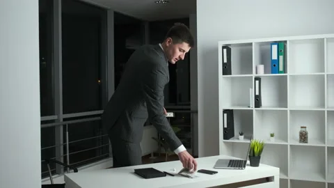 Young head of the company stayed in the office at work until night and lists the Stock Footage 134160344