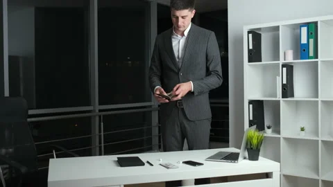 Young head of the company stayed in the office at work until night and lists the Stock Footage 136823055