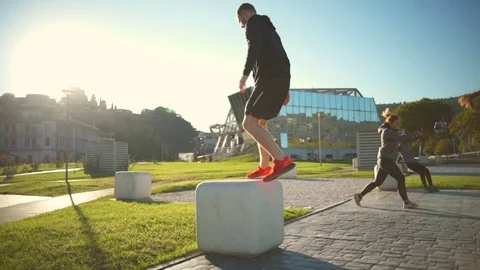 Young healthy friends doing different exercises outdoors slow motion Stock Footage 70965942