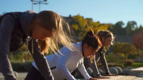 Young healthy friends doing push ups in the beautiful park slow motion Stock Footage 70966685