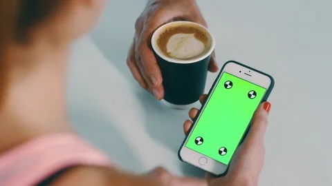 Young healthy lady at cafe checking emails on iPhone early morning light  Stock Footage 73815260