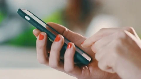 Young healthy lady at cafe checking emails on iPhone early morning light 2 Stock Footage 73990225