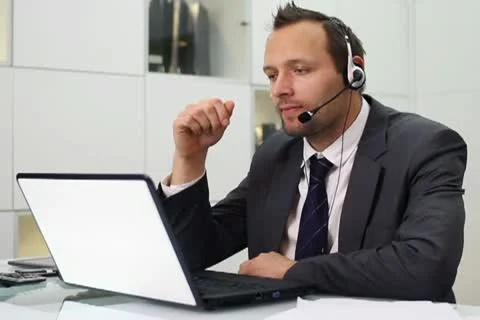 Young helpdesk consultant talking on headset in modern office NTSC Stock Footage 10745179