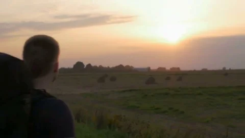 Young hiker with a backpack looking to the sky and enjoying freedom. Stock Footage 82234502