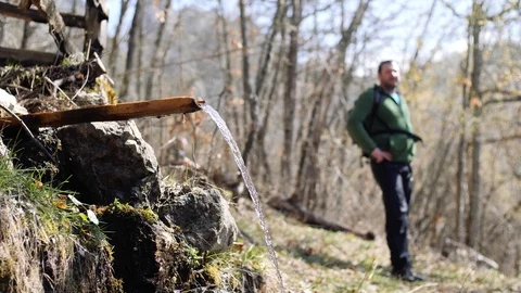 Young hiker drinking the mountain spring water Stock Footage 88303984