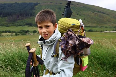 Young hiker with large backpack in open hilly landscape Stock Photos