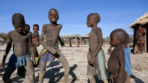 Young Himba kids dancing in traditional village in Namibia, Africa. Stock Footage