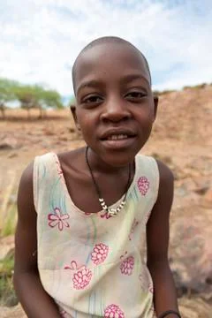 Young Himba posing in front of the camera at Epupa Falls in Namibia Stock Photos