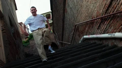 A young hip hop dancer is dancing on the stairs. Stock Footage 242145664
