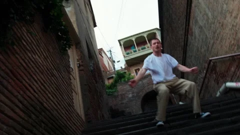 A young hip hop dancer is dancing on the stairs. Stock Footage 242145699