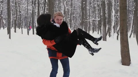 Young hipster couple having a walk in winter forest in slowmotion Stock Footage 59144767