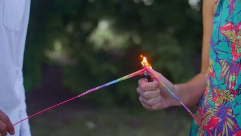 A young hipster couple lights their sparklers Stock Footage