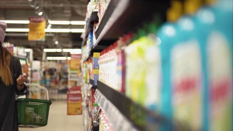 A young hipster female chooses dish soap in the store Stock Footage 80736067