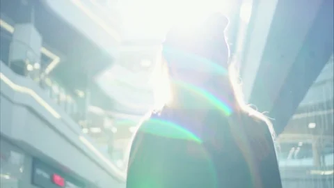 A young hipster female portrait near shop windows at sunset Stock Footage