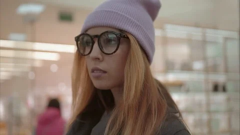 A young hipster female portrait in the store near shop windows Stock Footage 80734059