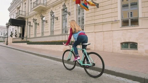 A young hipster girl riding a fixed Stock Video Pond5