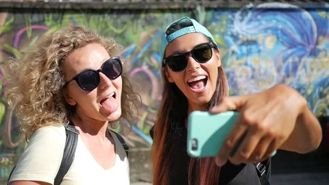 Young Hipster Girls Doing Selfie on Smartphone While Standing Next to the Stock Footage