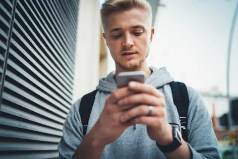 Young hipster guy using  smartphone outdoor Stock Photos