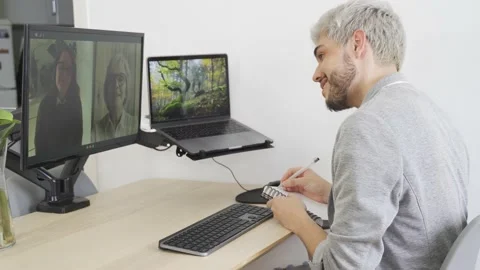 Young hipster man doing video call meeting with his colleagues Stock Footage 168967371