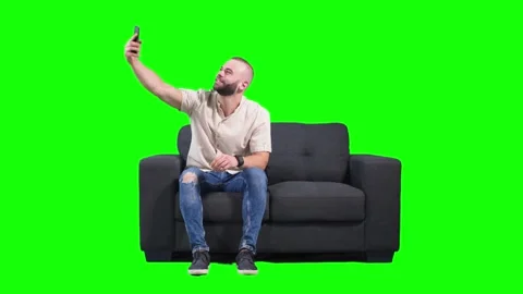 Young hipster man having fun taking selfies at home Stock Footage 136369038