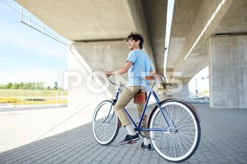 Young hipster man riding fixed gear bike Stock Photos