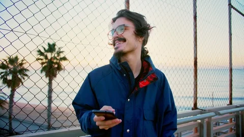 Young hipster man with smartphone app checking social network news feed internet Stock Footage 100862099