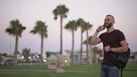 Young hipster man talking on mobile phone in city Stock Footage 136370326