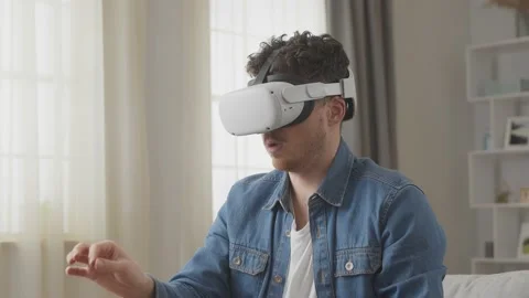 Young hipster man using his VR headset for communicates via video call while Stock Footage 169320645