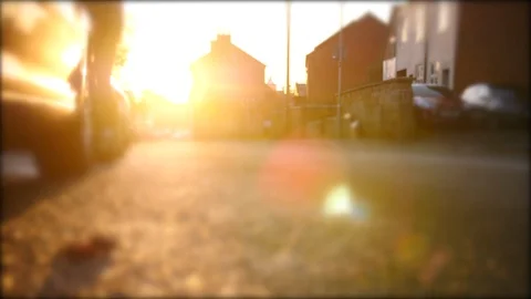 Young hipster man walking crossing over British road  in town at sunset  Stock Footage 85771284