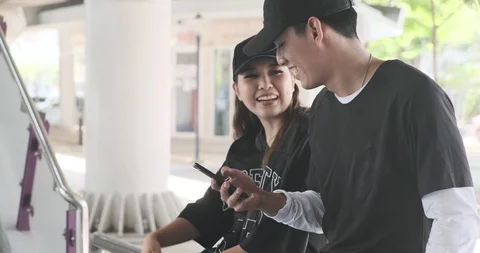 Young hipster singing together using mobile phone on street with copy space. Stock Footage 106375737