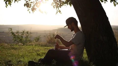 Young hipster sitting on grass in park. Stock Footage 116721096