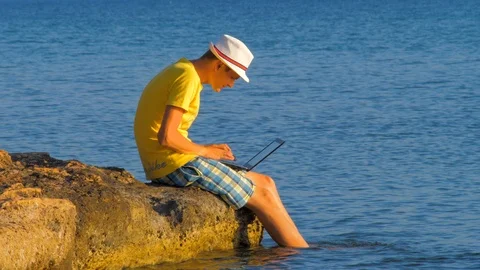 Young hipster using laptop computer, concept of tourist. Man working on laptop Stock Footage 124231021