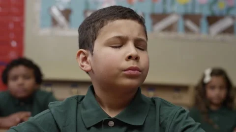 Young hispanic boy looks at the camera with angry look. Student with depression. Stock Footage 141757984