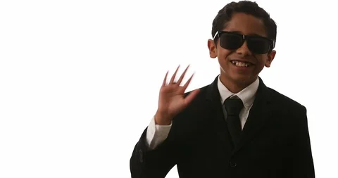 Young Hispanic Boy Smiles Waves And points Toward Camera Stock Footage 104844492