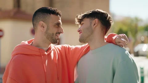 Young hispanic couple smiling confident hugging each other speaking at street Video stock 170634954
