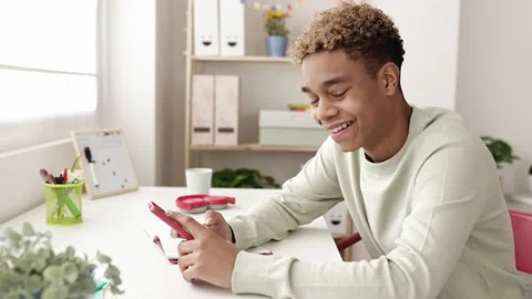Young hispanic latin man using mobile phone in room Stock Footage 181887806
