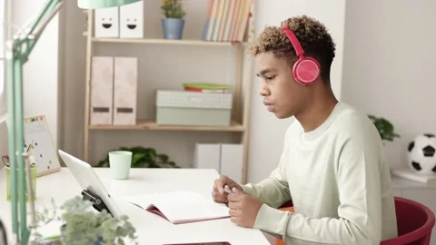 Young hispanic latino man using digital table to study online at home Vidéo 182852430