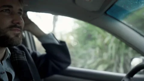 Young hispanic man adjusts his hair while driving Video stock 201202537