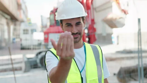 Young hispanic man architect smiling confident doing coming gesture at street Video stock 221690079