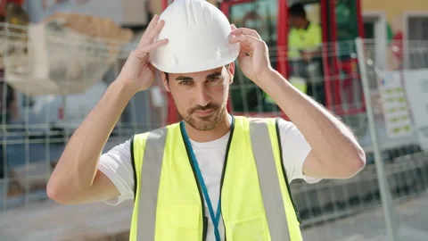 Young hispanic man architect smiling confident wearing hardhat at street Video stock 221690145