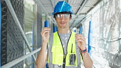 Young hispanic man architect smiling confident wearing security glasses at .. Video stock 247384861