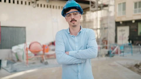 Young hispanic man architect standing with arms crossed gesture at street Stock Footage 171050766