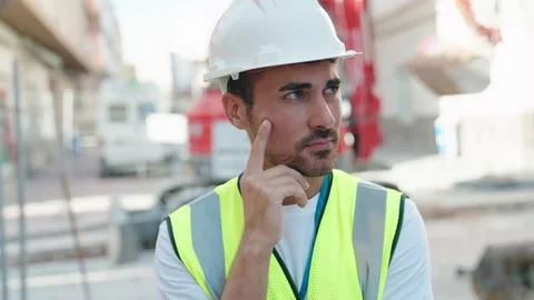 Young hispanic man architect standing with doubt expression at street Video stock 220143540