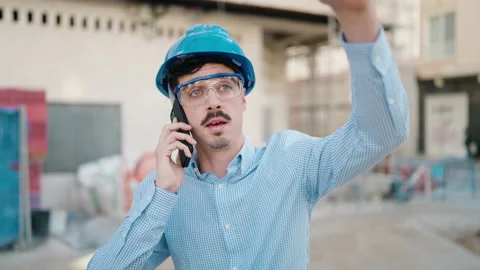 Young hispanic man architect talking on the smartphone at street Video stock 171800893