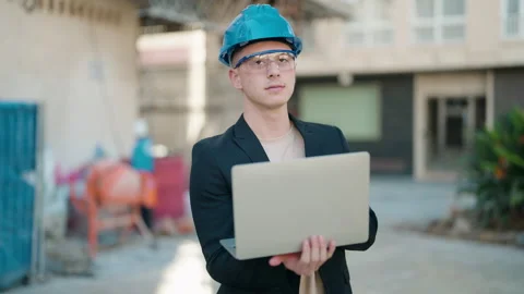 Young hispanic man architect using laptop standing at street Stock Footage 171040753