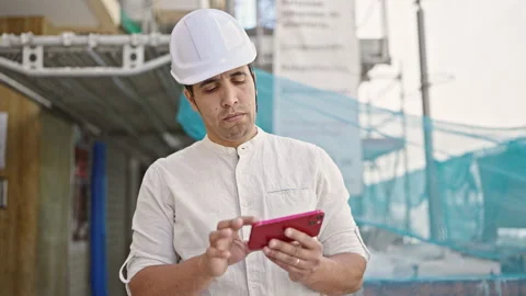 Young hispanic man architect using smartphone at street Video stock 245023831