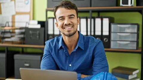 Young hispanic man architect using laptop working at office Video stock 245031740